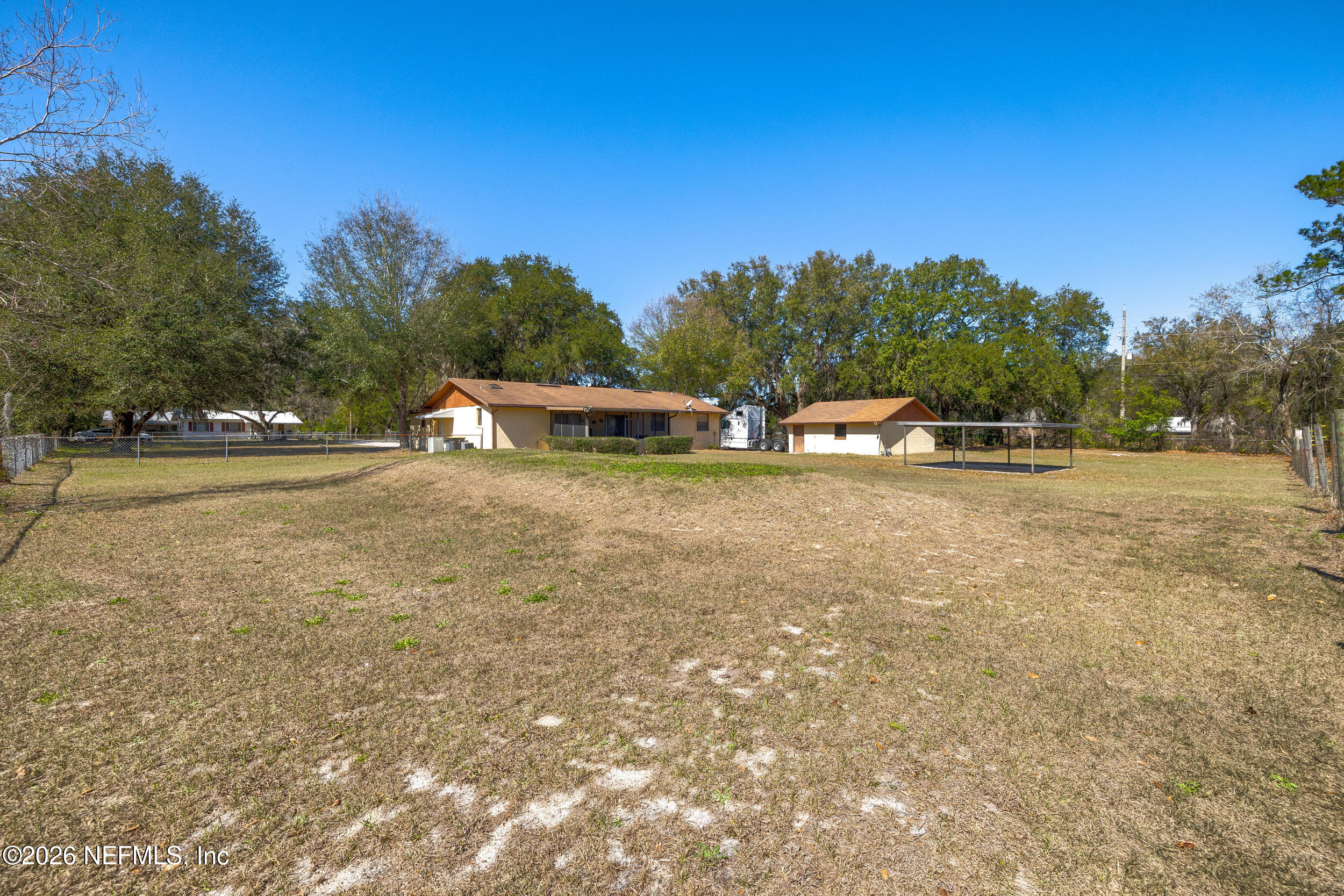 4065 Magill Road Jacksonville, FL 32220 - Photo 38 of 42 a view of a field with trees in the background