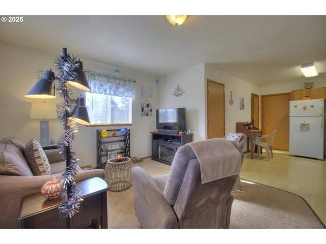 a kitchen with stainless steel appliances granite countertop a refrigerator a stove and a sink