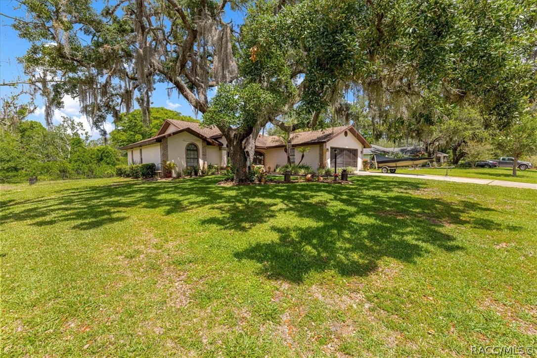 2964 South Cygnet Terrace Inverness, FL 34450 - Photo 63 of 67 a front view of a house with a yard