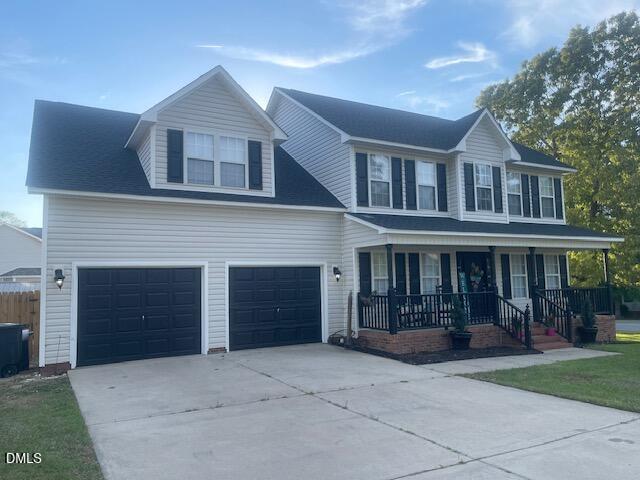 705 Crystal Spring Drive Sanford, NC 27332 - Photo 19 of 21 a front view of a house with a yard and potted plants