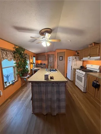 a kitchen with stainless steel appliances a table and chairs in it