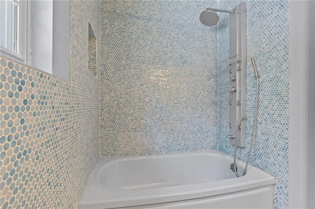 2105 Fortview Road Austin, TX 78704 - Photo 29 of 37 A well-appointed bath with a full tile surround and modern shower fixtures.