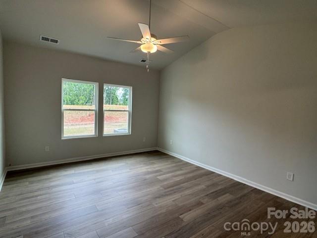 206 Rodeo Drive Shelby, NC 28150 - Photo 11 of 19 an empty room with wooden floor chandelier fan and windows