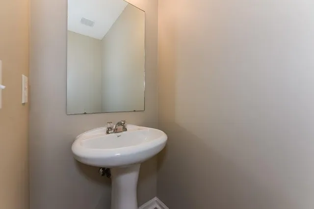a bathroom with a sink and mirror