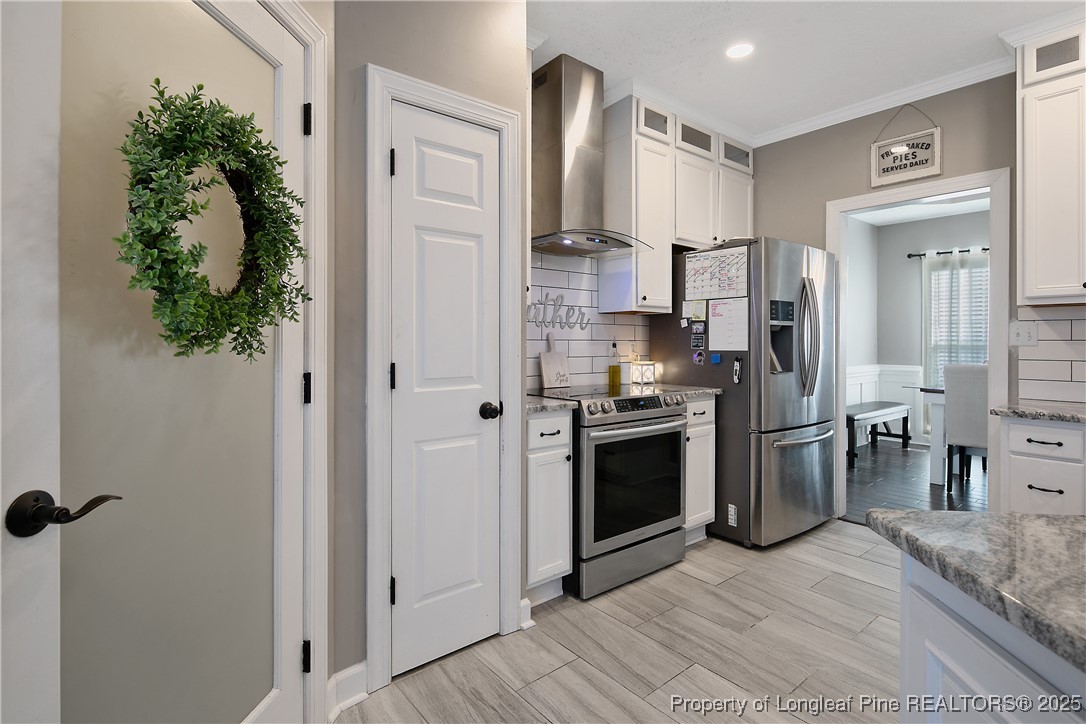 3524 Talus Road Fayetteville, NC 28306 - Photo 21 of 47 a kitchen with a refrigerator and a stove