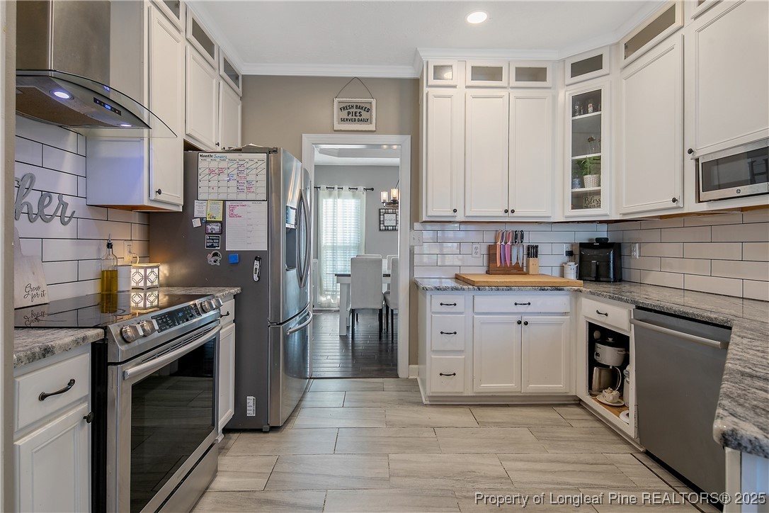 3524 Talus Road Fayetteville, NC 28306 - Photo 22 of 47 a kitchen with stainless steel appliances granite countertop a stove a sink and a refrigerator