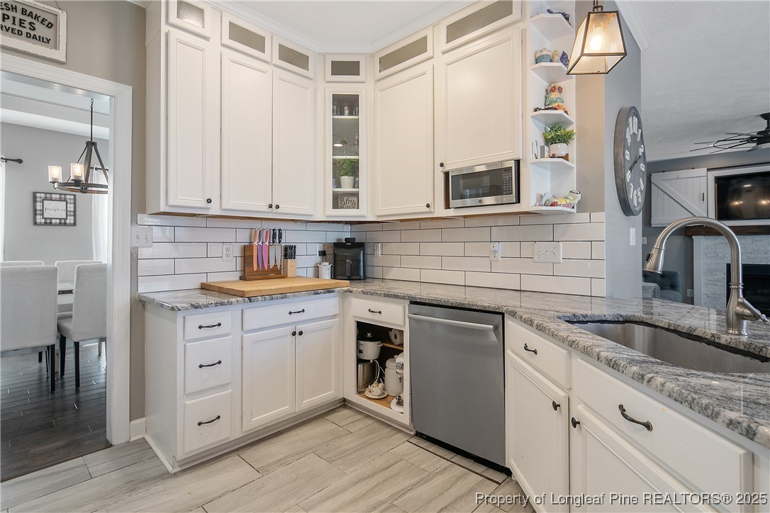 3524 Talus Road Fayetteville, NC 28306 - Photo 23 of 47 a kitchen with granite countertop a sink stainless steel appliances and cabinets