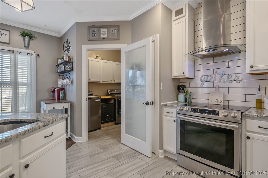 3524 Talus Road Fayetteville, NC 28306 - Photo 26 of 47 a kitchen with a stove and a refrigerator