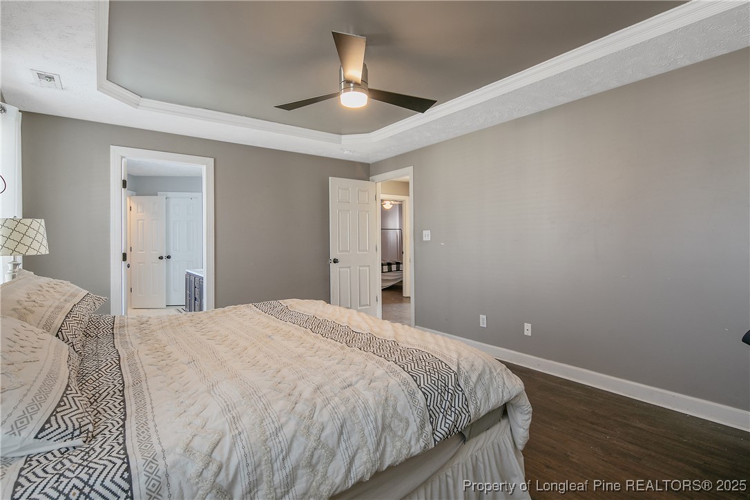 3524 Talus Road Fayetteville, NC 28306 - Photo 30 of 47 a bedroom with a bed and a ceiling fan