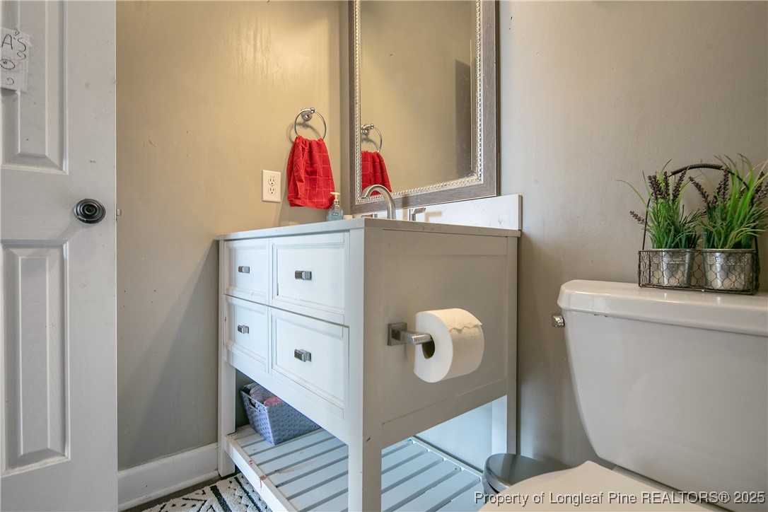 3524 Talus Road Fayetteville, NC 28306 - Photo 41 of 47 a bathroom with a toilet and a shower curtain