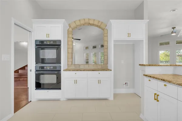 a kitchen with stainless steel appliances granite countertop a stove and a refrigerator