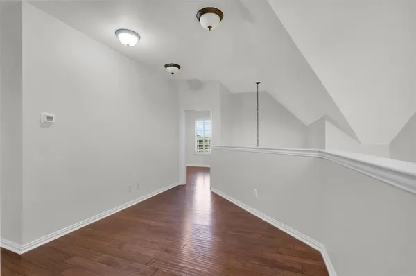 a view of a room with wooden floor
