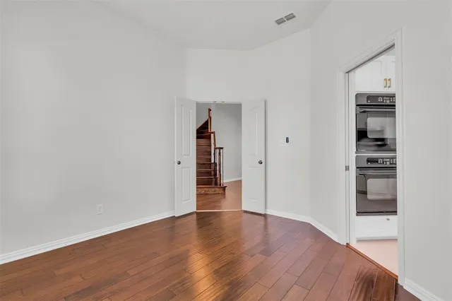 a view of a room with wooden floor and closet
