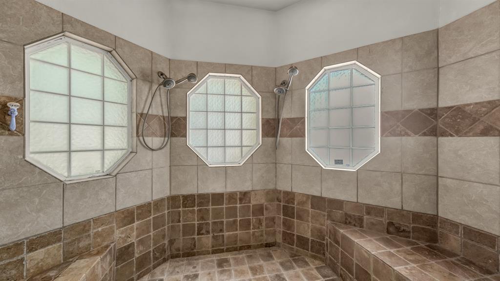 203 Mockingbird Lane Aledo, TX 76008 - Photo 27 of 37 Spacious tiled shower featuring three octagonal privacy windows, two showerheads, and integrated bench seating