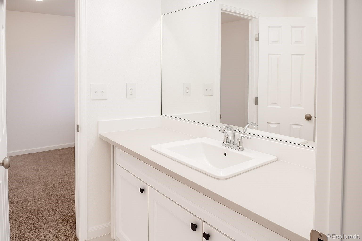3583 East Uintah Street, Unit 102 Colorado Springs, CO 80909 - Photo 11 of 23 a bathroom with a sink and a mirror