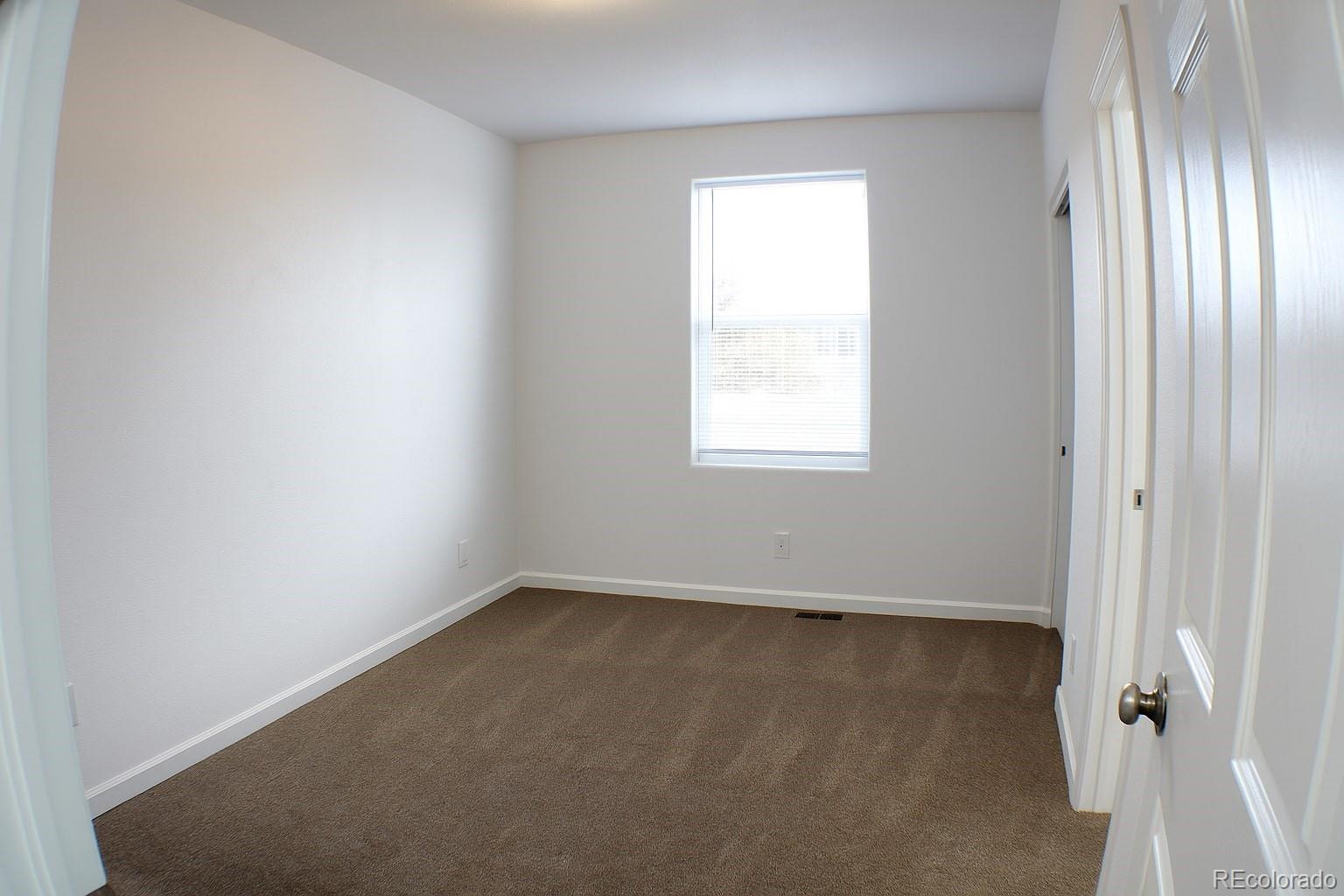 3583 East Uintah Street, Unit 102 Colorado Springs, CO 80909 - Photo 12 of 23 an empty room with windows