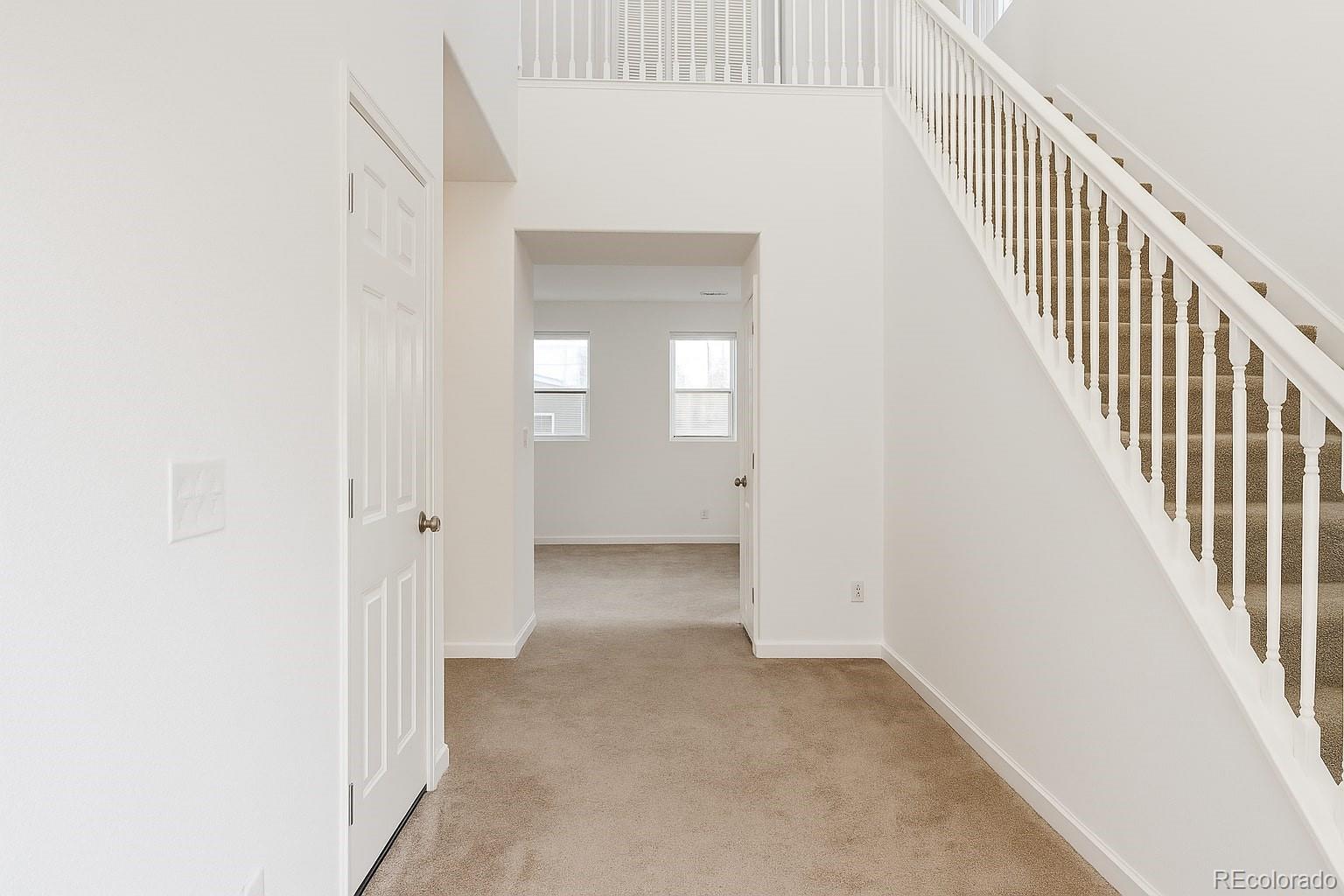 3583 East Uintah Street, Unit 102 Colorado Springs, CO 80909 - Photo 2 of 23 a view of a hallway with wooden floor and entryway