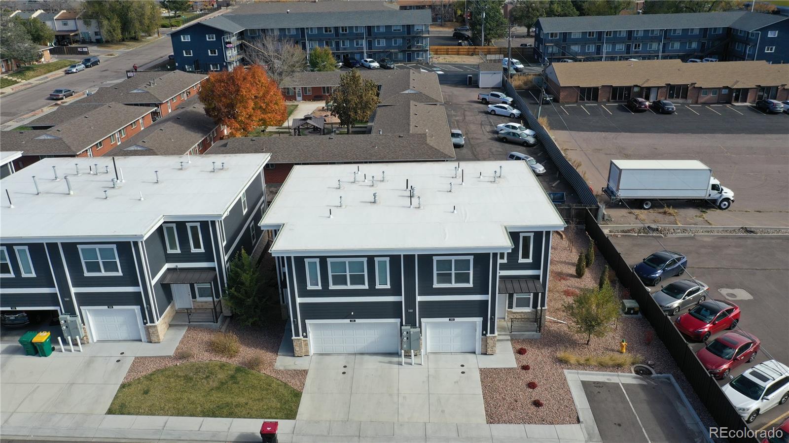 3583 East Uintah Street, Unit 102 Colorado Springs, CO 80909 - Photo 21 of 23 an aerial view of a house with swimming pool