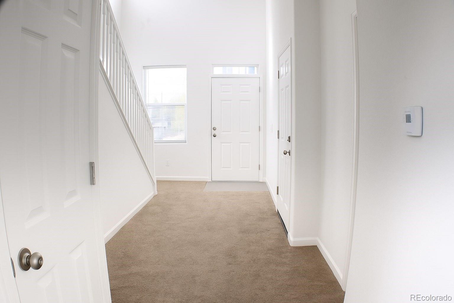 3583 East Uintah Street, Unit 102 Colorado Springs, CO 80909 - Photo 6 of 23 a view of a hallway with wooden floor and entryway