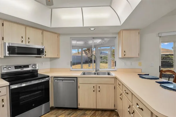 a kitchen with a sink stove and microwave