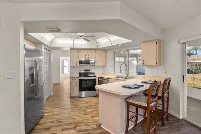 a kitchen with stainless steel appliances a stove a sink dishwasher and a refrigerator