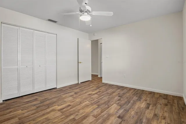 a view of an empty room with wooden floor