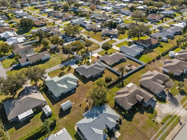 an aerial view of a building with parking