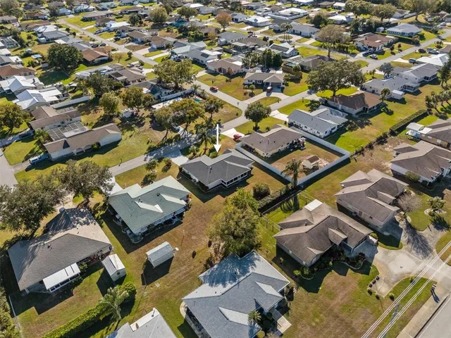 an aerial view of a building with parking
