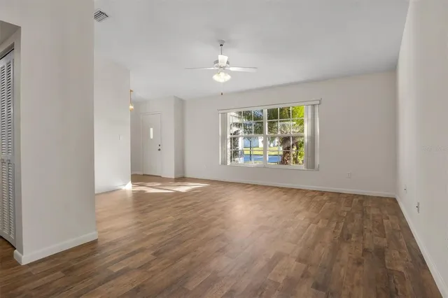 wooden floor in an empty room with a window