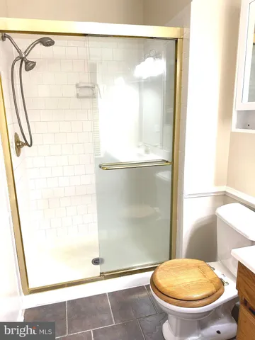 a bathroom with a toilet and a shower