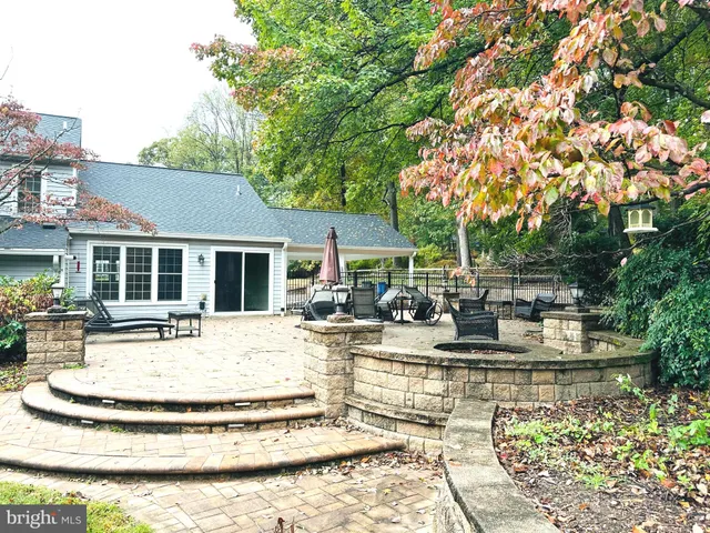 a view of a house with swimming pool and sitting area