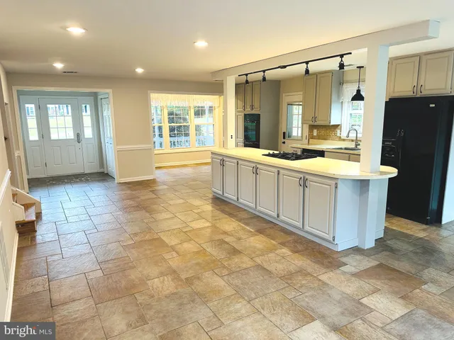 a large bathroom with a tub a sink a mirror and a shower