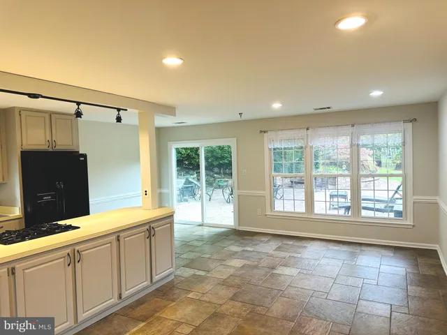 a spacious bathroom with a granite countertop sink and a large mirror