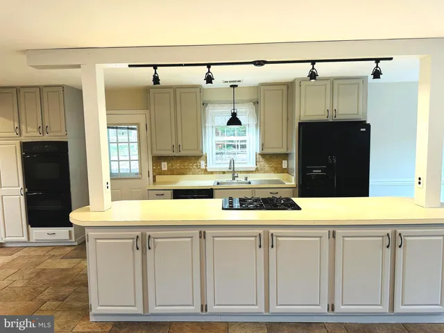 a kitchen with a refrigerator and a sink