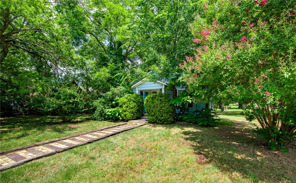 1619 McCormick Street Denton, TX 76205 - Photo 3 of 12 a view of a garden with a bench