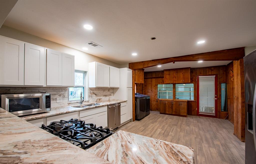 1619 McCormick Street Denton, TX 76205 - Photo 6 of 12 a kitchen with stainless steel appliances granite countertop a stove and a refrigerator