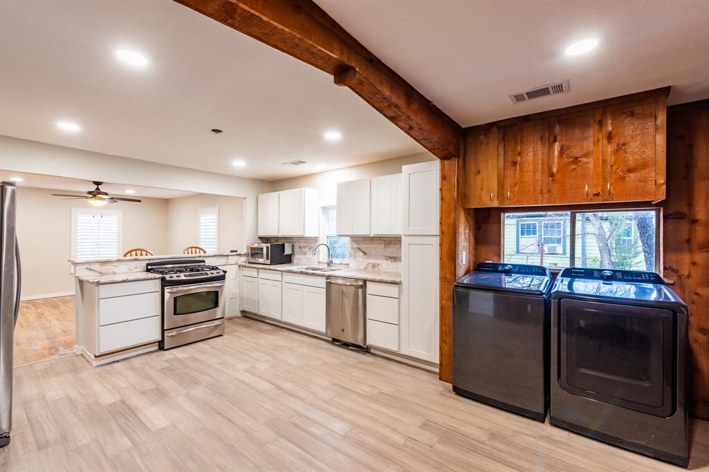 1619 McCormick Street Denton, TX 76205 - Photo 9 of 12 a kitchen with stainless steel appliances granite countertop a stove and a refrigerator