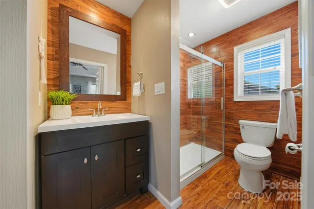 a bathroom with a sink a toilet a tub and shower