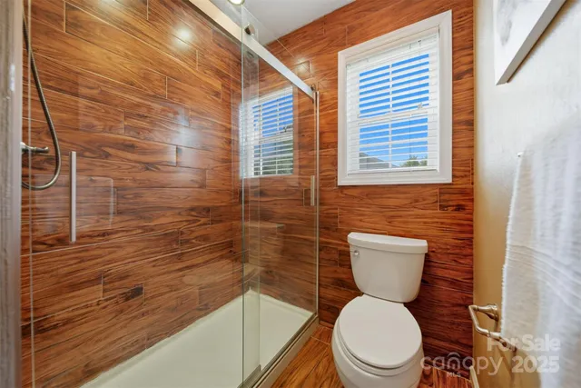 a bathroom with a toilet and a shower