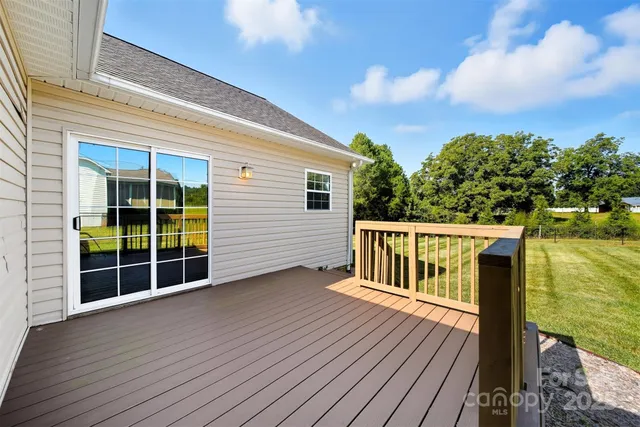 a view of deck with large trees and wooden floor