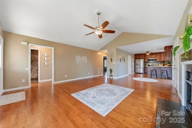 a living room with hard wood floors and a rug