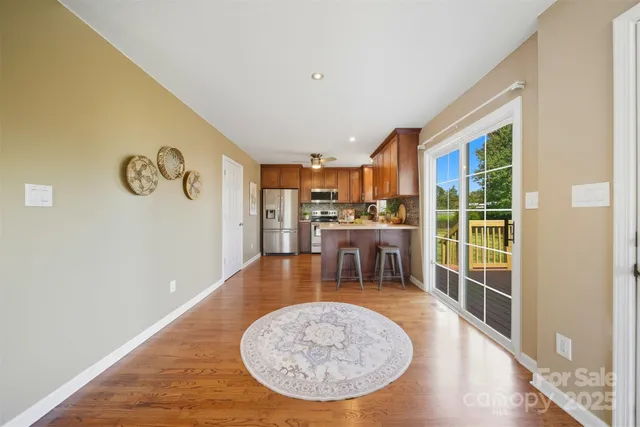 a view of a livingroom with furniture wooden floor and a fireplace