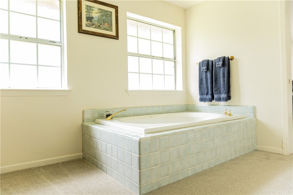 39301 Moonray Lane Oakhurst, CA 93644 - Photo 16 of 41 a bathroom with a tub sink and window