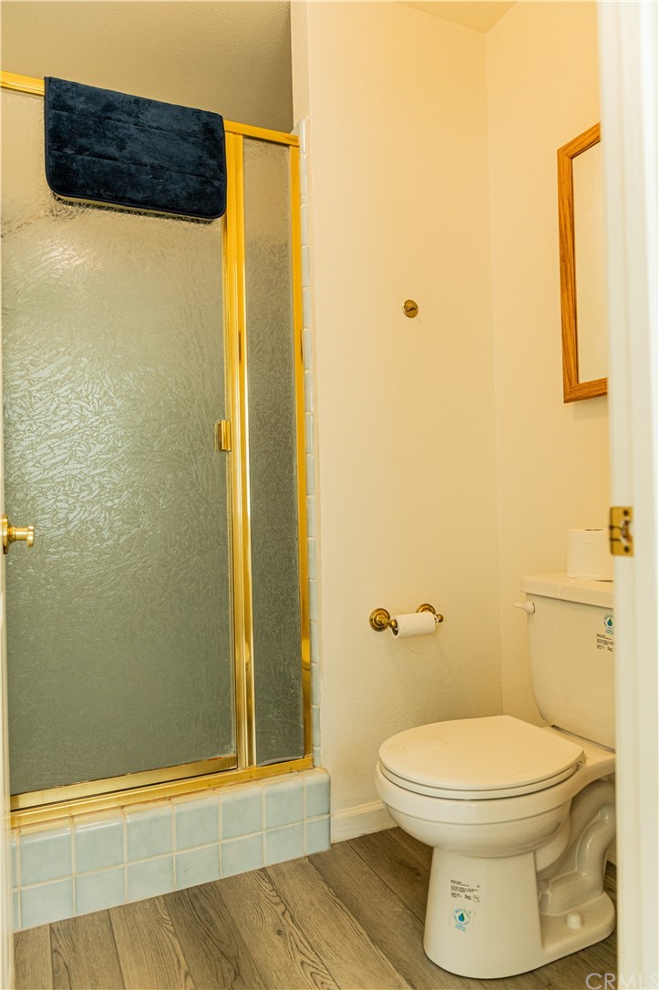 39301 Moonray Lane Oakhurst, CA 93644 - Photo 20 of 41 a bathroom with a toilet and a shower