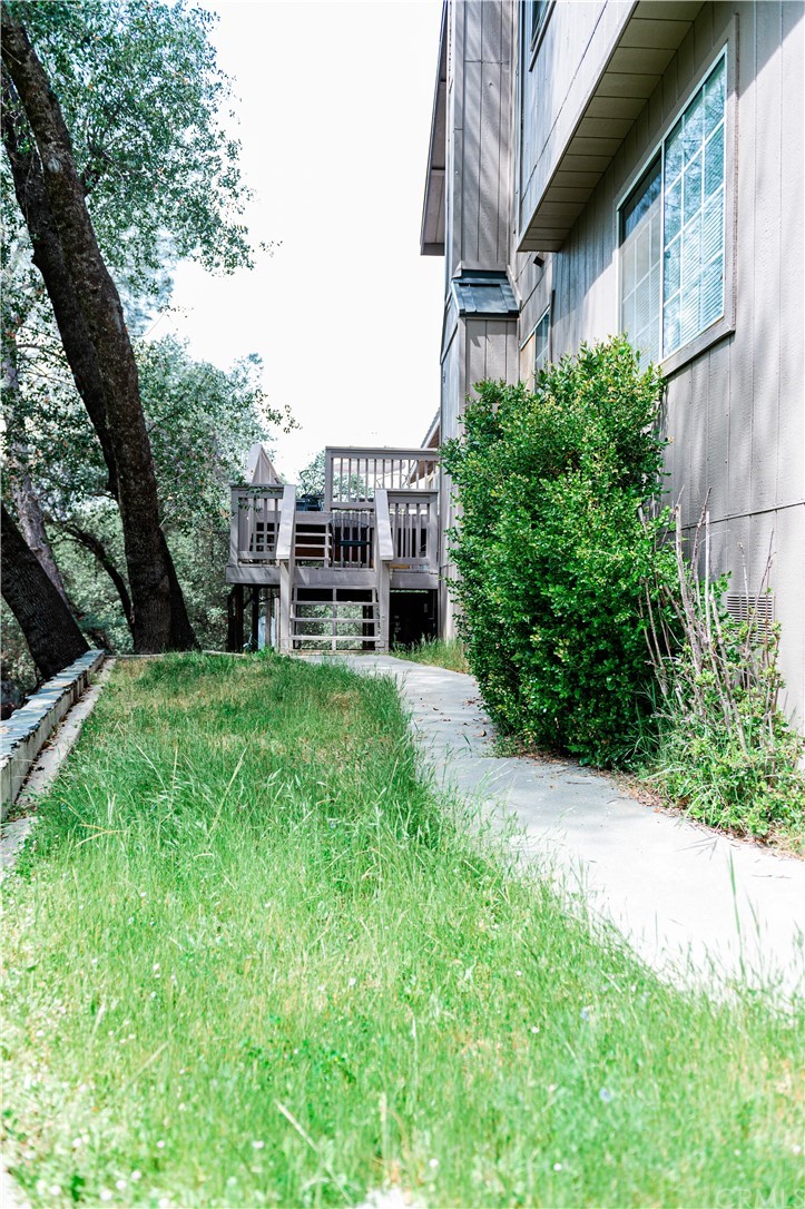 39301 Moonray Lane Oakhurst, CA 93644 - Photo 39 of 41 a view of a house with a big yard plants and large trees