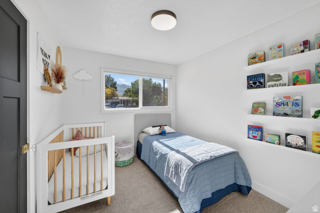 66 South 425 West Bountiful, UT 84010 - Photo 15 of 25 Bright room featuring a window overlooking natural scenery, recessed shelving, neutral wall paint, and carpet flooring