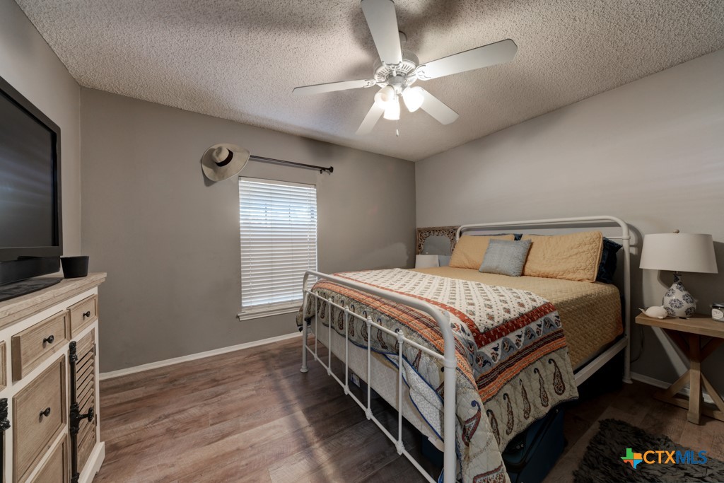 1229 Rapids Road New Braunfels, TX 78130 - Photo 13 of 27 a bedroom with a bed and a flat screen tv