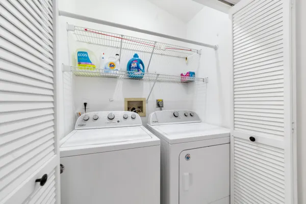 a living room with couch a flat screen tv and a floor to ceiling window