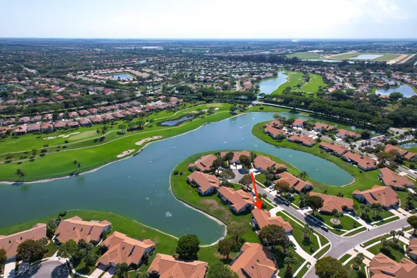 a outdoor space with lots of wooden furniture and a chandelier