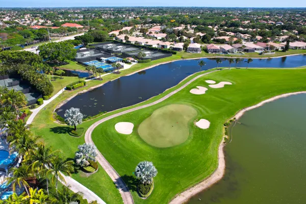 an aerial view of a residential houses with outdoor space and swimming pool